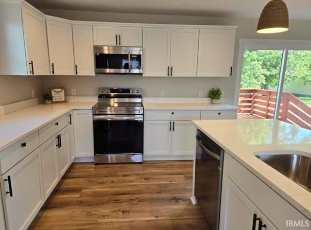 5317 Stellhorn Rd, Fort Wayne, IN 46815 - kitchen with stainless steel appliances, white cabinets, wood finished floors, and light countertops