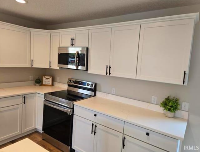 5317 Stellhorn Rd, Fort Wayne, IN 46815 - kitchen with stainless steel appliances, white cabinetry, recessed lighting, and a textured ceiling