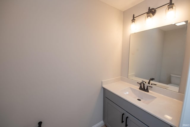 909 S Hoke Ave, Frankfort, IN 46041 - bathroom with toilet, vanity, and baseboards