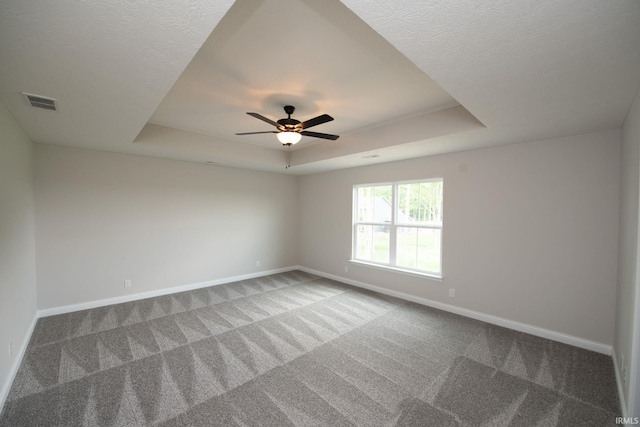 909 S Hoke Ave, Frankfort, IN 46041 - carpeted empty room with a tray ceiling, baseboards, and ceiling fan