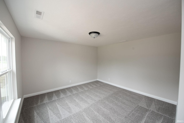 909 S Hoke Ave, Frankfort, IN 46041 - spare room with dark carpet and baseboards
