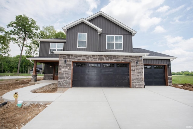 909 S Hoke Ave, Frankfort, IN 46041 - view of front of property featuring board and batten siding, stone siding, and concrete driveway