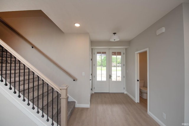 909 S Hoke Ave, Frankfort, IN 46041 - entryway with baseboards, wood finished floors, stairs, and french doors