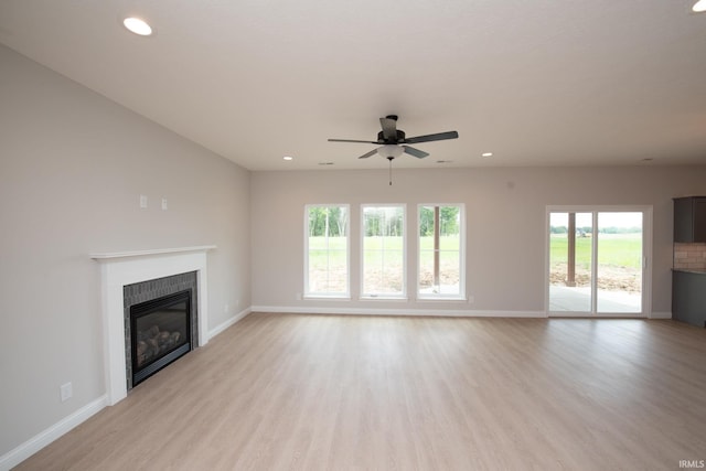 909 S Hoke Ave, Frankfort, IN 46041 - unfurnished living room featuring a glass covered fireplace, baseboards, and recessed lighting