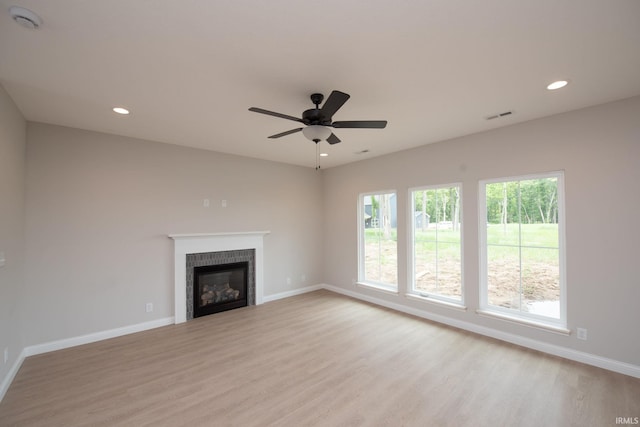 909 S Hoke Ave, Frankfort, IN 46041 - unfurnished living room with light wood-style flooring, baseboards, a fireplace, recessed lighting, and a ceiling fan