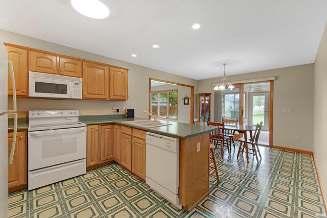 2104 Shady Ln, Garrett, IN 46738 - kitchen with white appliances, a sink, a peninsula, a chandelier, and recessed lighting