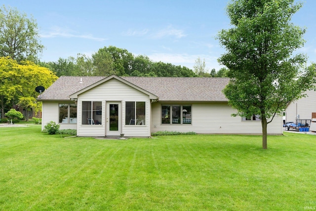 2104 Shady Ln, Garrett, IN 46738 - rear view of property with a lawn, a shingled roof, and a sunroom