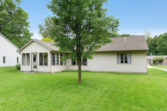 2104 Shady Ln, Garrett, IN 46738 - back of property with a lawn, a sunroom, and a shingled roof