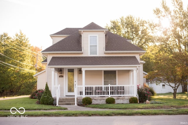 203 N Cross St, Hillsboro, IN 47949 - view of front facade with roof with shingles, covered porch, and a front lawn