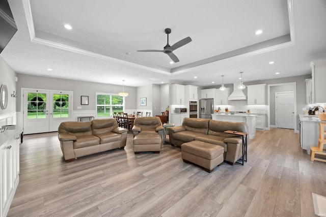 7018 S 350 St E, Lafayette, IN 47909 - living area with a tray ceiling, light wood-style floors, a ceiling fan, recessed lighting, and a wainscoted wall
