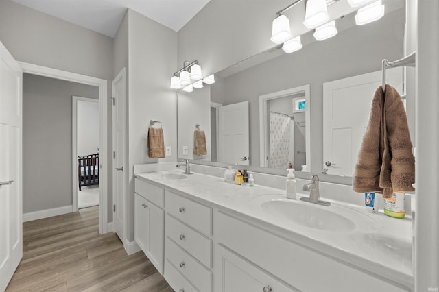 7018 S 350 St E, Lafayette, IN 47909 - bathroom featuring double vanity, wood finished floors, and baseboards