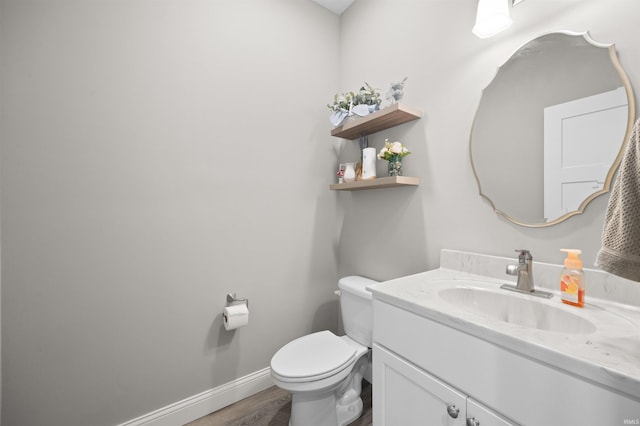 7018 S 350 St E, Lafayette, IN 47909 - half bathroom featuring wood finished floors, vanity, baseboards, and toilet