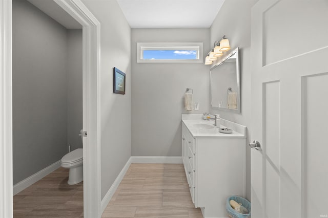 7018 S 350 St E, Lafayette, IN 47909 - bathroom featuring toilet, vanity, baseboards, and wood finished floors