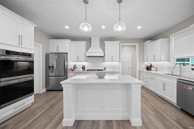 7018 S 350 St E, Lafayette, IN 47909 - kitchen with stainless steel appliances, custom exhaust hood, recessed lighting, white cabinetry, and a center island