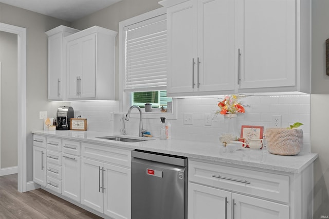 7018 S 350 St E, Lafayette, IN 47909 - kitchen with stainless steel dishwasher, a sink, white cabinets, tasteful backsplash, and light wood-style floors
