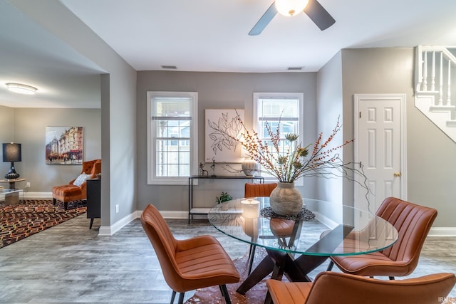 807 W Washington Blvd, Fort Wayne, IN 46802 - dining room featuring wood finished floors, stairs, ceiling fan, and baseboards