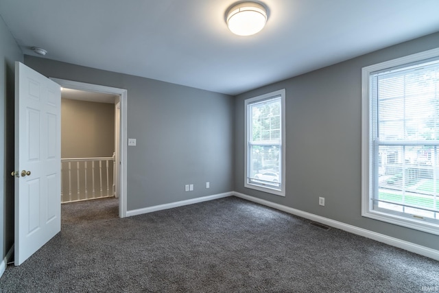 807 W Washington Blvd, Fort Wayne, IN 46802 - empty room with dark colored carpet, plenty of natural light, a smoke detector, and baseboards
