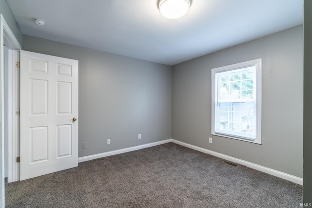 807 W Washington Blvd, Fort Wayne, IN 46802 - unfurnished room featuring dark colored carpet and baseboards