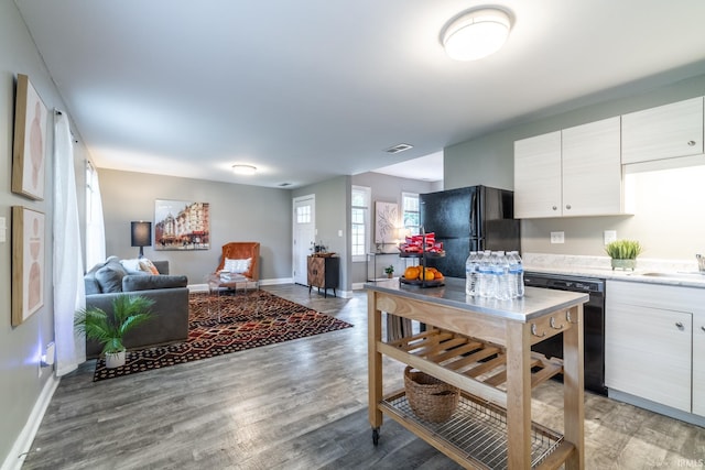 807 W Washington Blvd, Fort Wayne, IN 46802 - kitchen featuring black appliances, baseboards, light wood-style flooring, light countertops, and open floor plan
