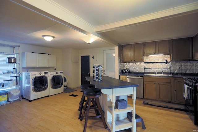 482 E Jefferson St, Andrews, IN 46702 - kitchen with separate washer and dryer, stainless steel dishwasher, dark countertops, and gas stove