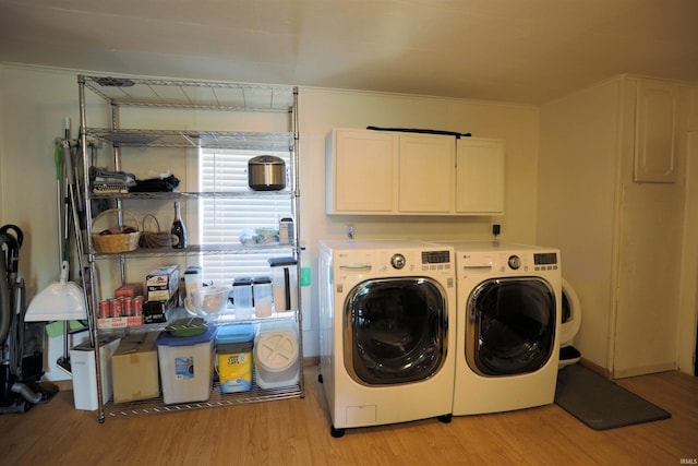 482 E Jefferson St, Andrews, IN 46702 - laundry area with cabinet space, light wood-style floors, and washer and clothes dryer