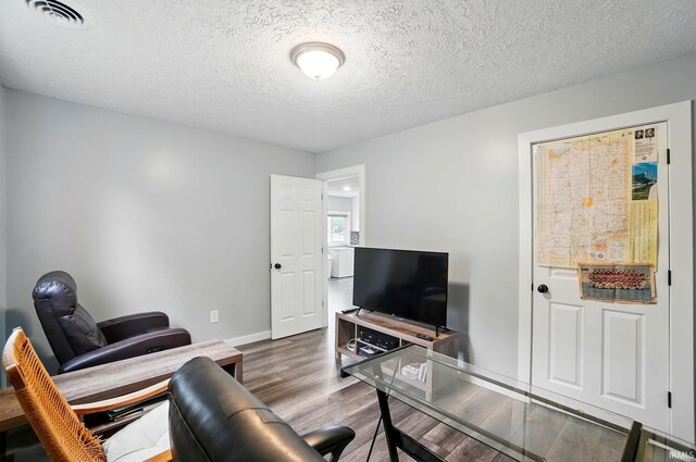 202 E Pickwick Dr, Syracuse, IN 46567 - living area with an office area, wood finished floors, baseboards, and a textured ceiling