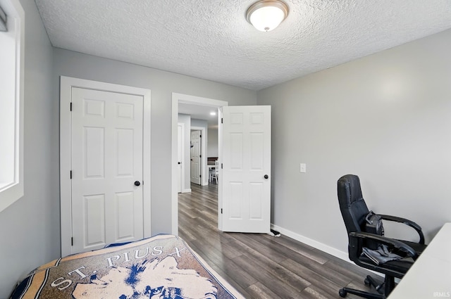 202 E Pickwick Dr, Syracuse, IN 46567 - unfurnished office featuring dark wood-style flooring, baseboards, and a textured ceiling