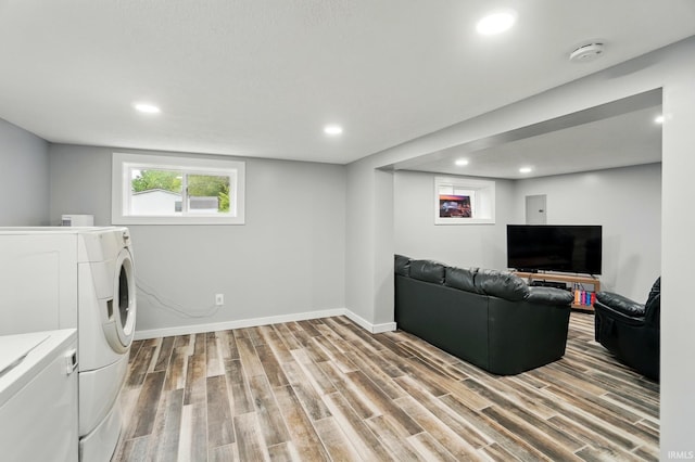 202 E Pickwick Dr, Syracuse, IN 46567 - unfurnished living room featuring light wood-type flooring, baseboards, recessed lighting, and independent washer and dryer