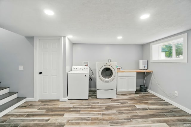 202 E Pickwick Dr, Syracuse, IN 46567 - laundry area featuring washing machine and dryer, cabinet space, light wood-style floors, recessed lighting, and baseboards