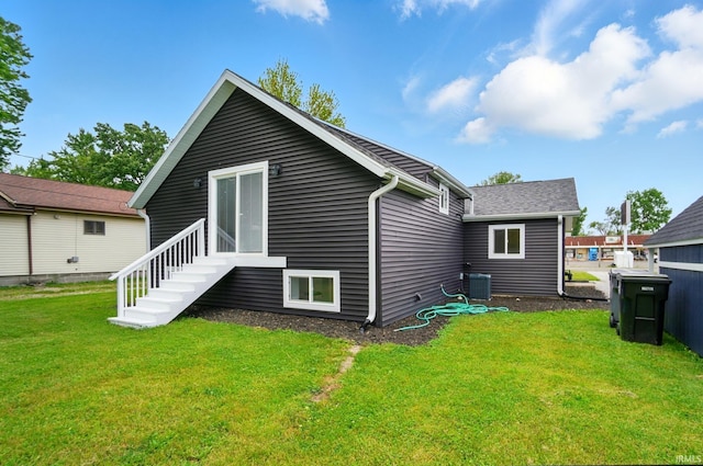 202 E Pickwick Dr, Syracuse, IN 46567 - back of house featuring central air condition unit, a lawn, and entry steps