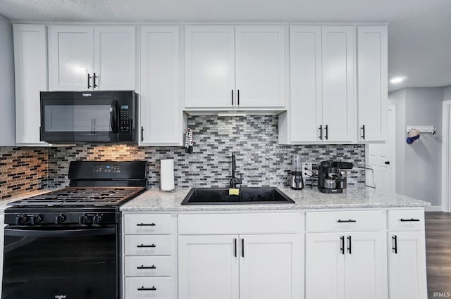 202 E Pickwick Dr, Syracuse, IN 46567 - kitchen featuring black appliances, a sink, white cabinetry, and decorative backsplash