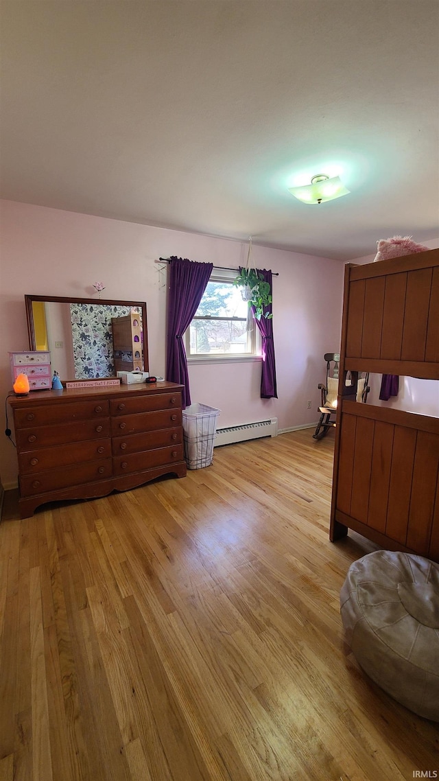 6403 Old Trail Rd, Fort Wayne, IN 46809 - bedroom featuring light wood-type flooring and a baseboard heating unit