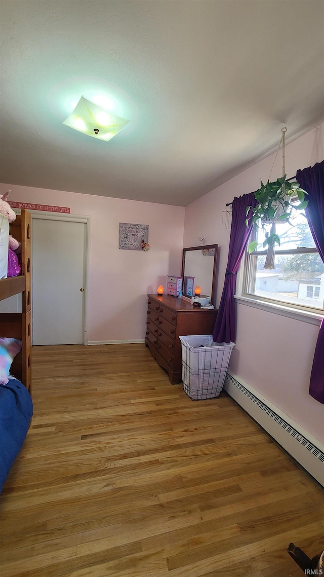 6403 Old Trail Rd, Fort Wayne, IN 46809 - bedroom with light wood finished floors, a baseboard radiator, and baseboards