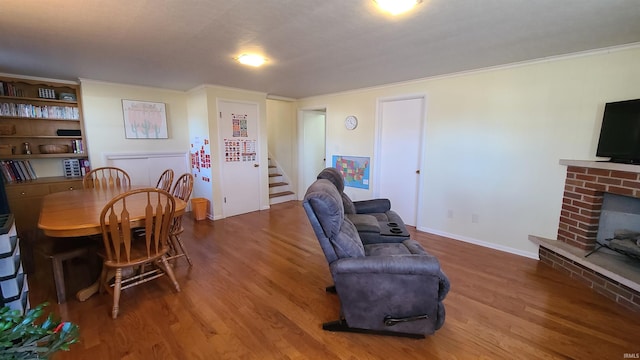 6403 Old Trail Rd, Fort Wayne, IN 46809 - living room with wood finished floors, stairway, a fireplace, crown molding, and baseboards