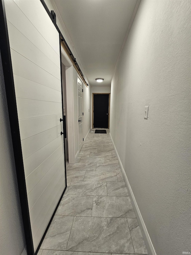 27 S Commerical St, Worthington, IN 47471 - corridor featuring a barn door, baseboards, and a textured wall