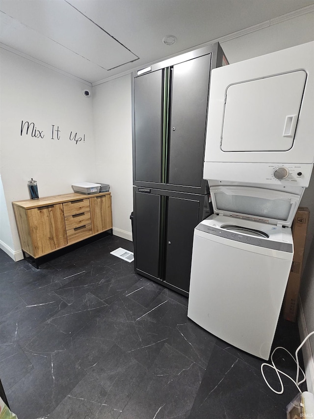 27 S Commerical St, Worthington, IN 47471 - laundry room with stacked washing machine and dryer, dark marble finish floors, and baseboards