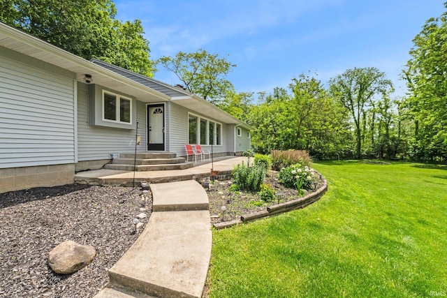 10317 Bass Rd, Fort Wayne, IN 46818 - view of exterior entry featuring a yard