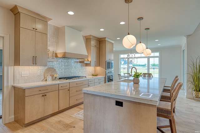 2909 Lake Dr, Newburgh, IN 47630 - kitchen featuring light brown cabinets, custom exhaust hood, a sink, appliances with stainless steel finishes, and a kitchen bar