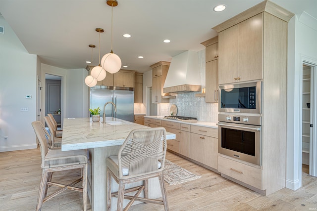 2909 Lake Dr, Newburgh, IN 47630 - kitchen featuring built in appliances, premium range hood, a sink, light brown cabinets, and recessed lighting