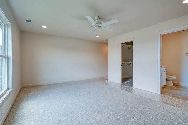 2909 Lake Dr, Newburgh, IN 47630 - unfurnished bedroom with multiple windows, light colored carpet, a walk in closet, recessed lighting, and baseboards