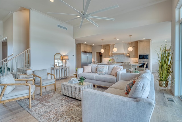 2909 Lake Dr, Newburgh, IN 47630 - living area featuring ceiling fan, light wood-style floors, stairs, a high ceiling, and recessed lighting
