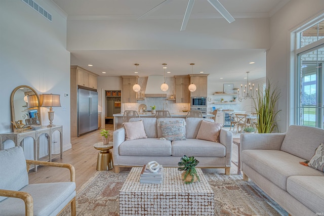 2909 Lake Dr, Newburgh, IN 47630 - living room featuring light wood-style flooring, a chandelier, baseboards, and recessed lighting