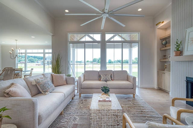 2909 Lake Dr, Newburgh, IN 47630 - living area featuring crown molding, a chandelier, a ceiling fan, light wood-type flooring, and recessed lighting