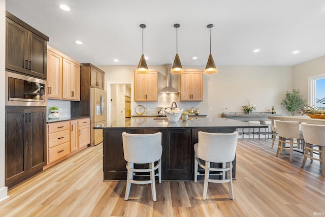 2088 Seward Lake Pass, Fort Wayne, IN 46814 - kitchen with wall chimney exhaust hood, stainless steel appliances, dark countertops, light wood finished floors, and backsplash