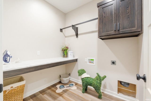 2088 Seward Lake Pass, Fort Wayne, IN 46814 - laundry area with hookup for an electric dryer, cabinet space, hookup for a washing machine, light wood-type flooring, and baseboards
