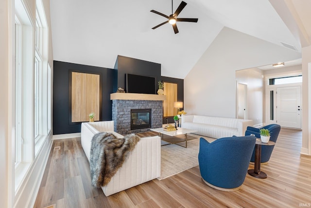 2088 Seward Lake Pass, Fort Wayne, IN 46814 - living room with high vaulted ceiling, a ceiling fan, light wood-style flooring, and a glass covered fireplace