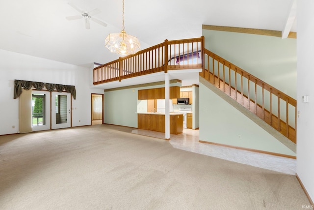 2223 Old Auburn Cv, Fort Wayne, IN 46845 - unfurnished living room featuring light colored carpet, high vaulted ceiling, a chandelier, stairway, and baseboards