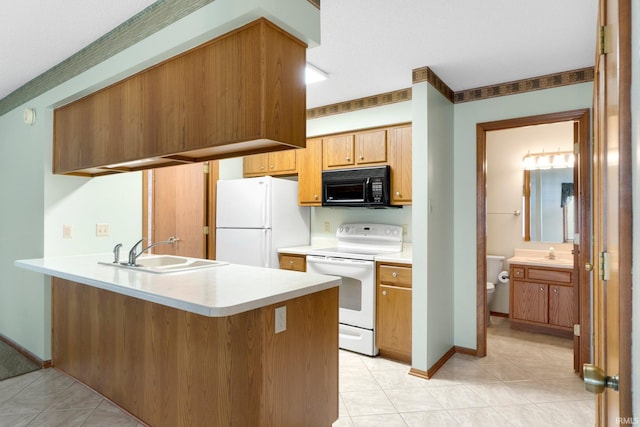 2223 Old Auburn Cv, Fort Wayne, IN 46845 - kitchen featuring white appliances, a sink, a peninsula, and light countertops