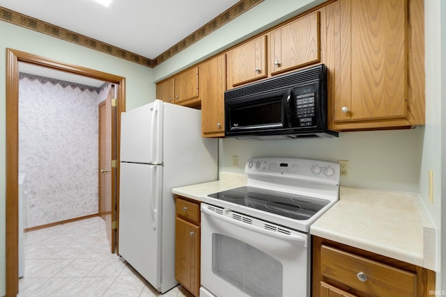 2223 Old Auburn Cv, Fort Wayne, IN 46845 - kitchen featuring white appliances, light countertops, and brown cabinetry