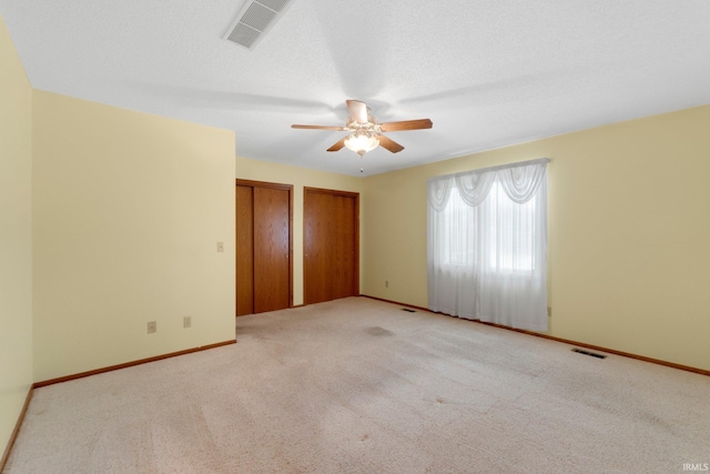 2223 Old Auburn Cv, Fort Wayne, IN 46845 - unfurnished bedroom with two closets, carpet flooring, and baseboards